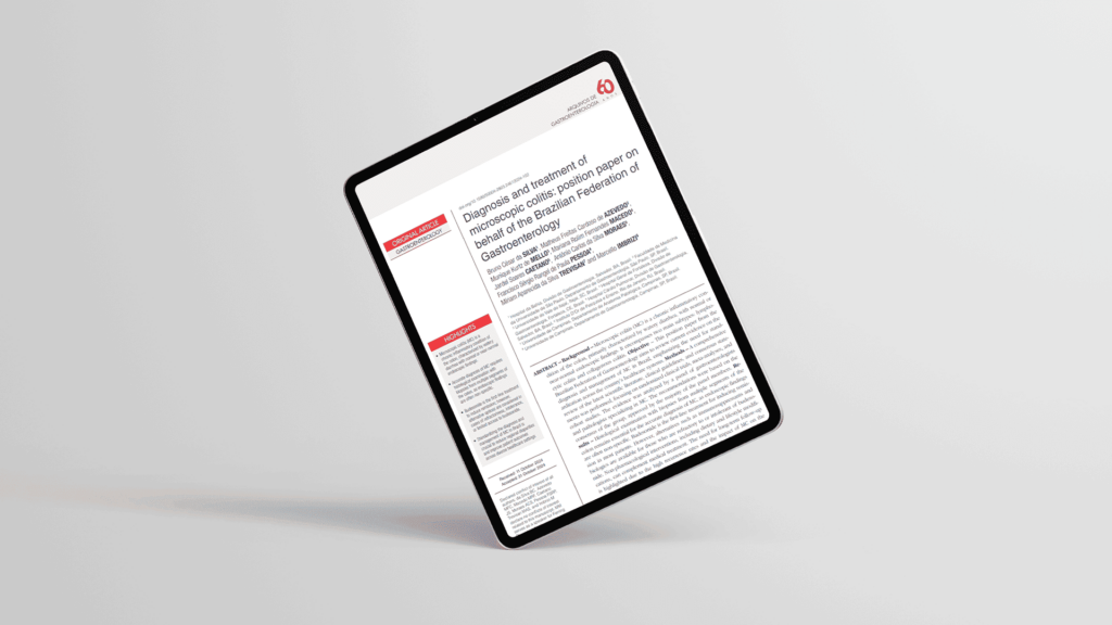 Imagem de tablet em fundo off-white mostrando artigo sobre estudo.