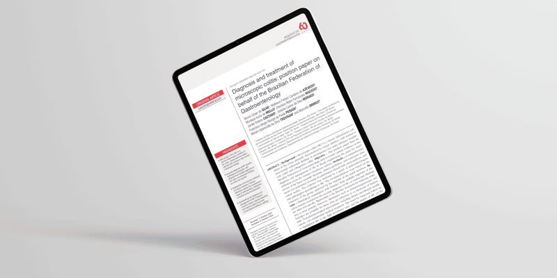 Imagem de tablet em fundo off-white mostrando artigo sobre estudo.